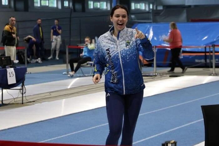 Alina Poloziuk celebrating on the competition floor after her result