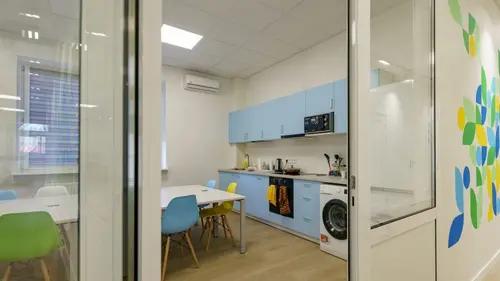 A bright communal kitchen and dining space inside a Save Ukraine reception center
