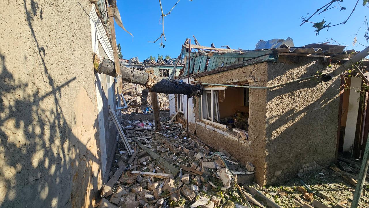 Rubble and debris between two damaged residential buildings in Kherson