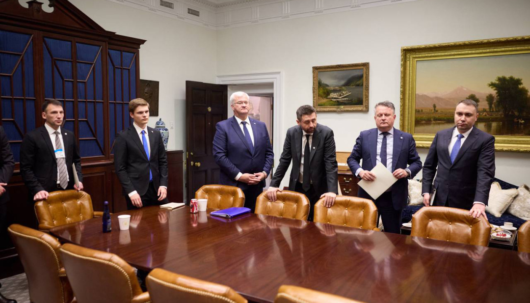 Ukrainian delegation seated at a conference table in the White House