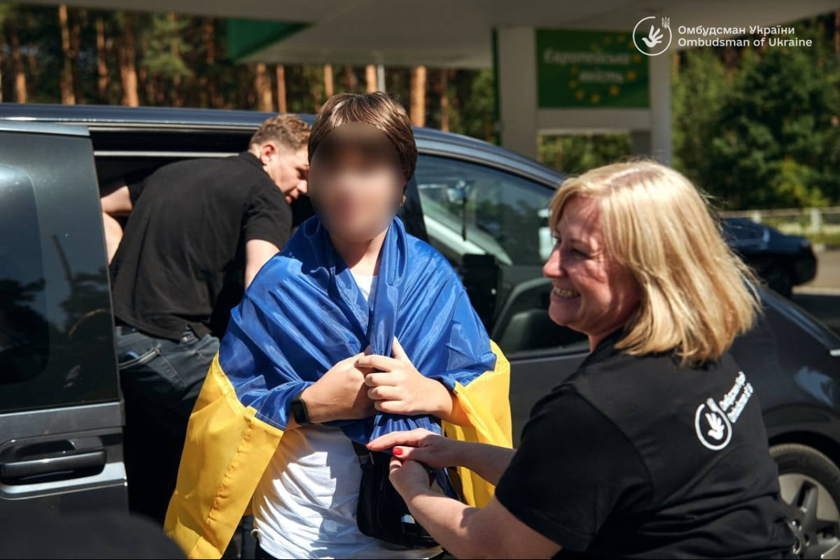 Підлітка, повернутого з окупації, зустрічають біля автівки з прапором України