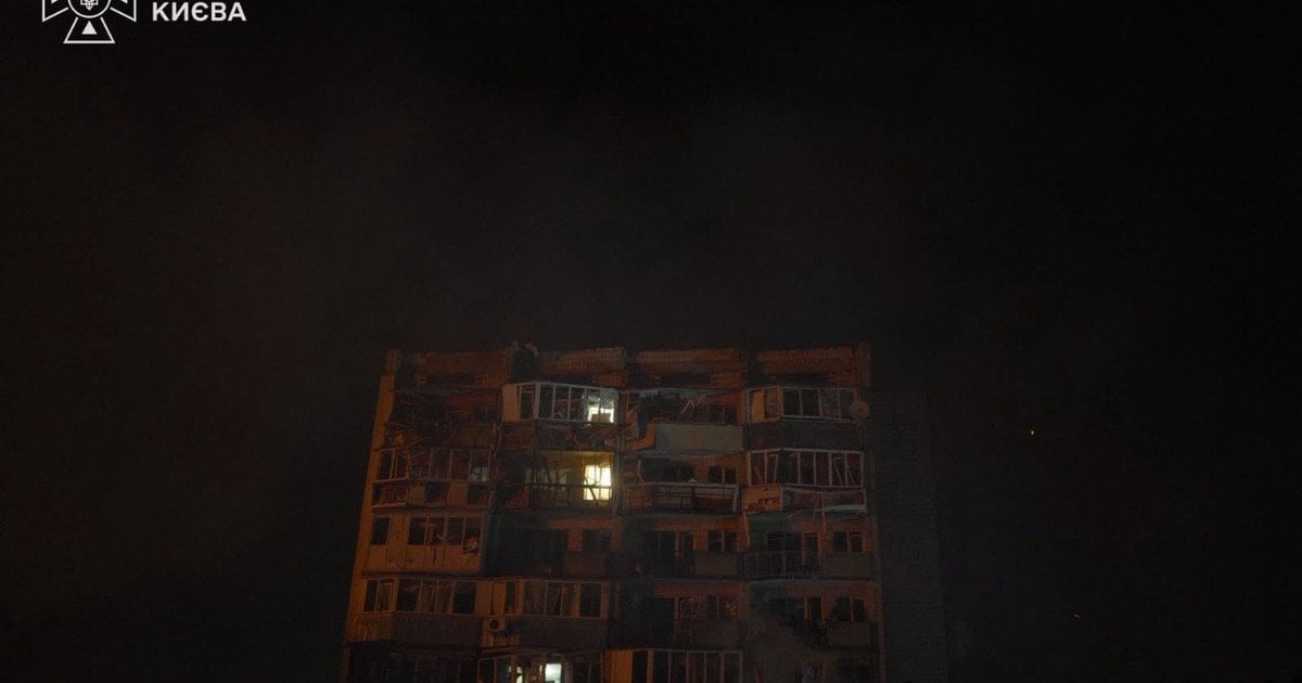 A Kyiv apartment block with blown-out windows and destroyed upper floors