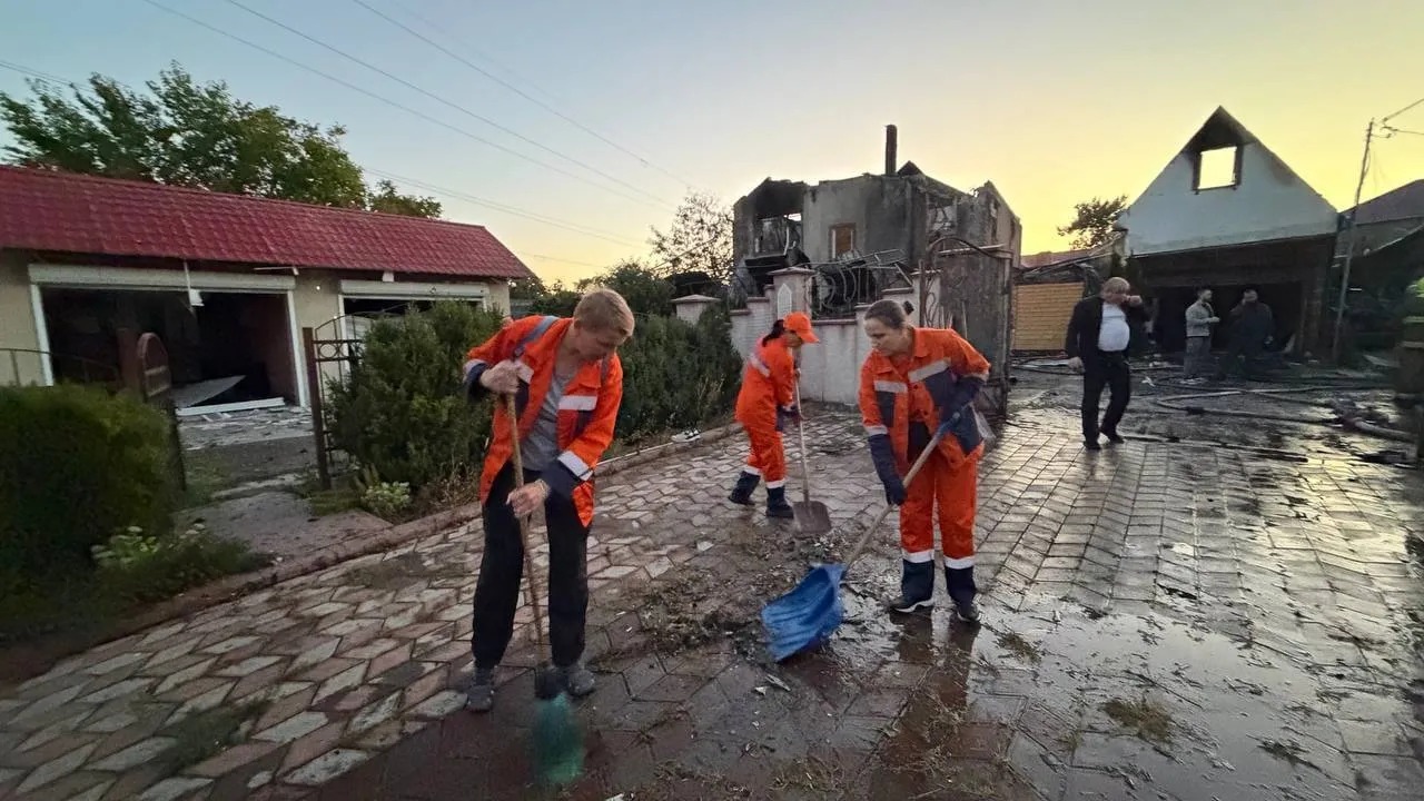Municipal crews clear debris near a damaged building in Odesa