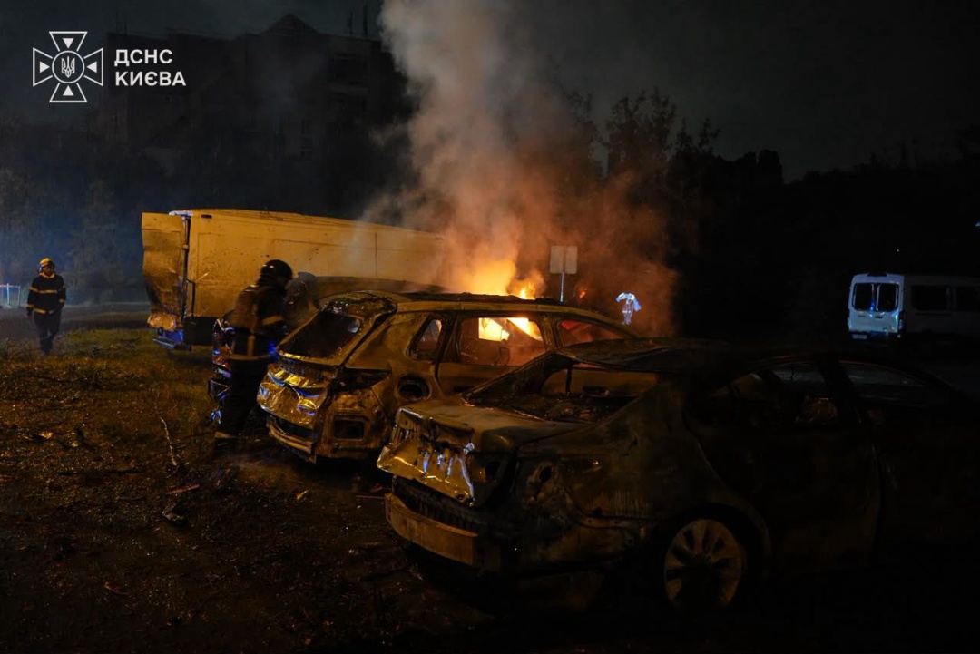 Kyiv emergency services extinguish a car fire after the missile attack on the capital