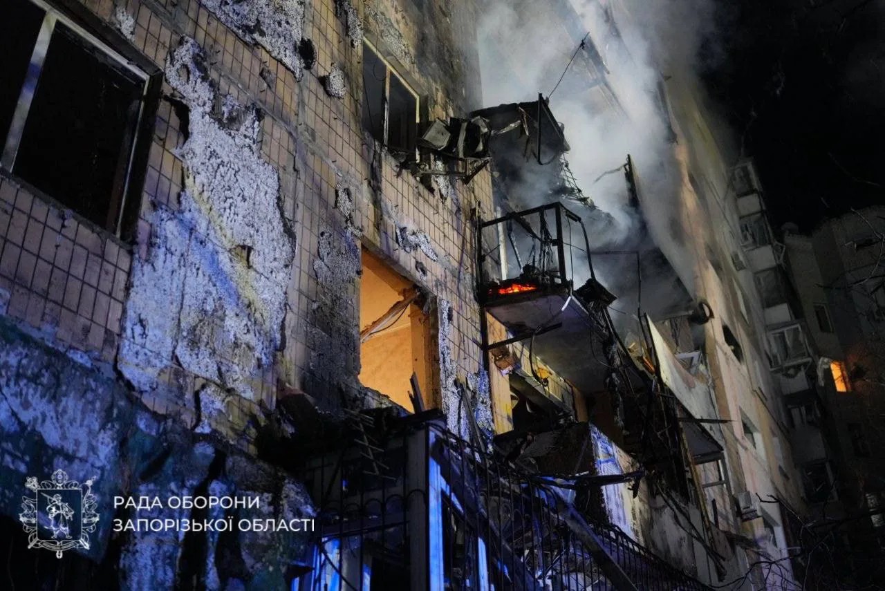 A high-rise apartment building in Zaporizhzhia with a burned-out balcony and shattered windows after the overnight drone attack