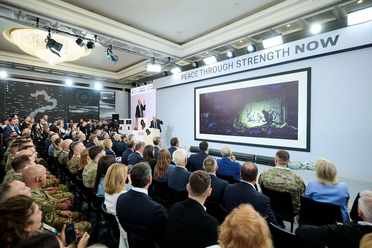 The Yalta European Strategy forum hall in Kyiv, with a "Peace Through Strength NOW" banner