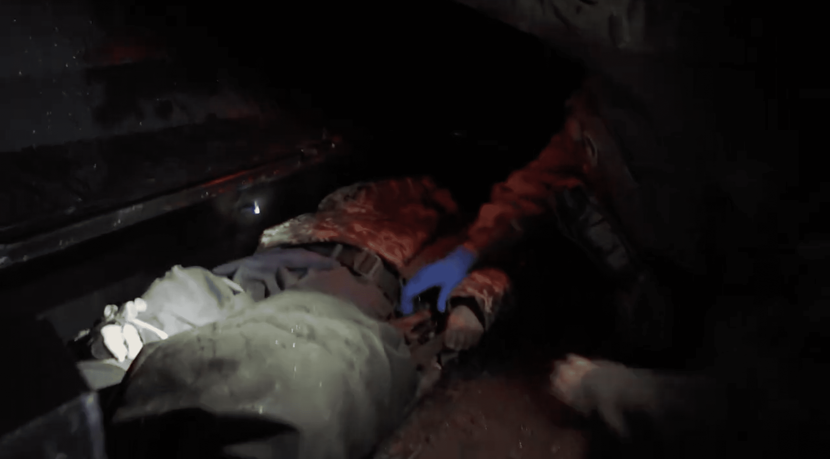 A Ukrainian medic assists the wounded soldier immediately after evacuation in the MAUL's armored capsule