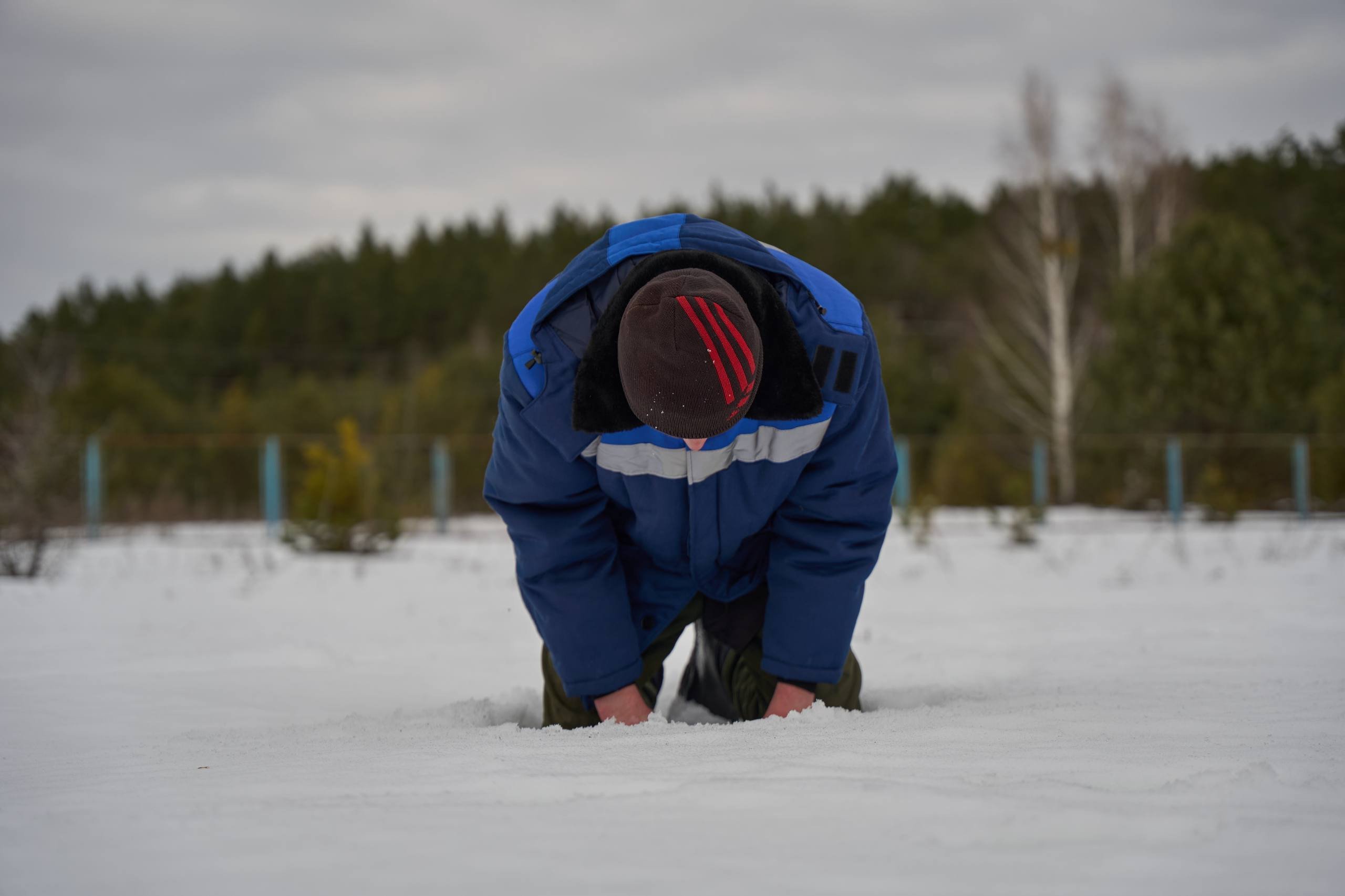 A freed defender kneels after returning from captivity (previous exchange, March 2026)