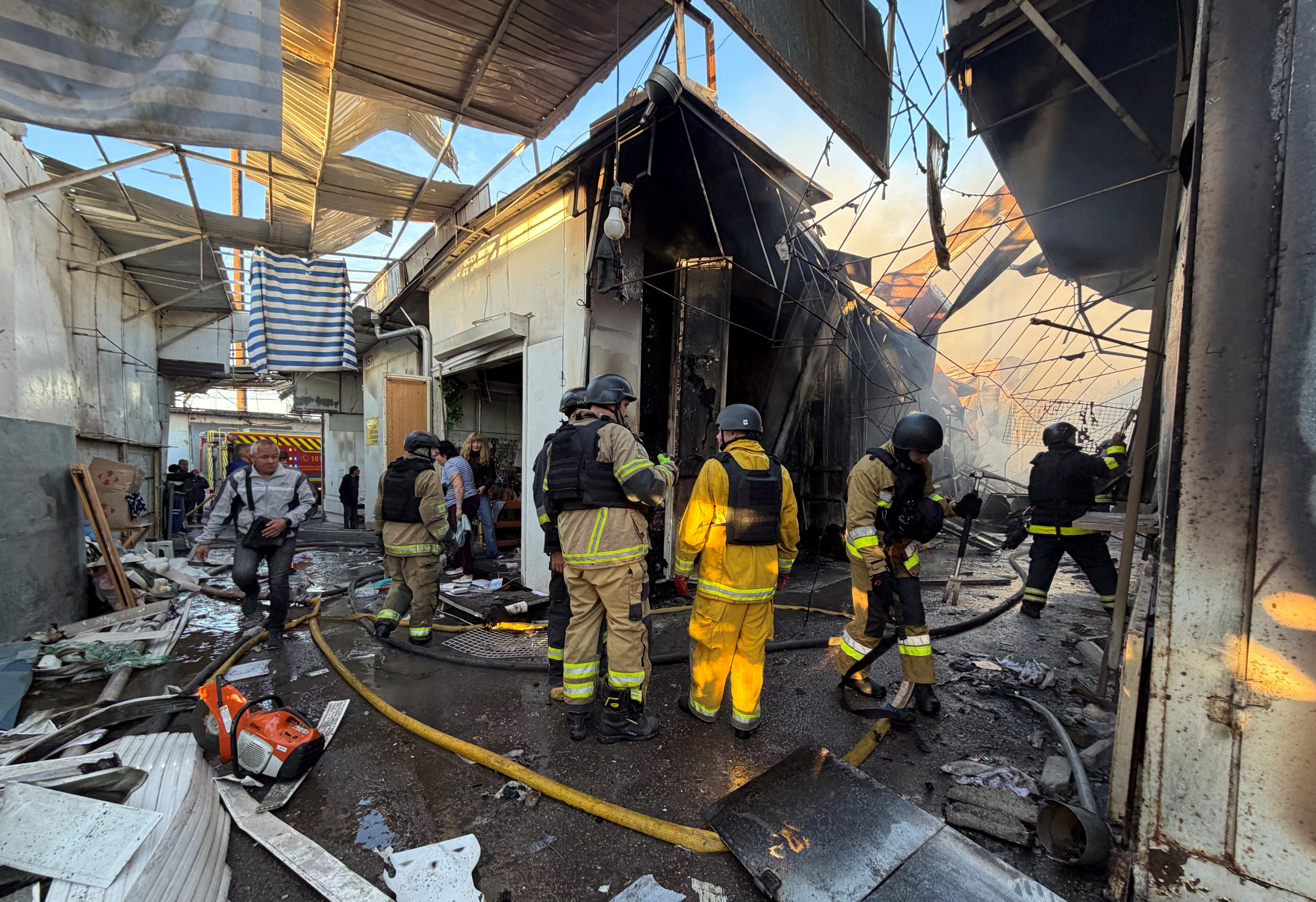 Rescuers inspect damage at a local market after a drone strike, Zaporizhzhia, Sept. 26, 2026