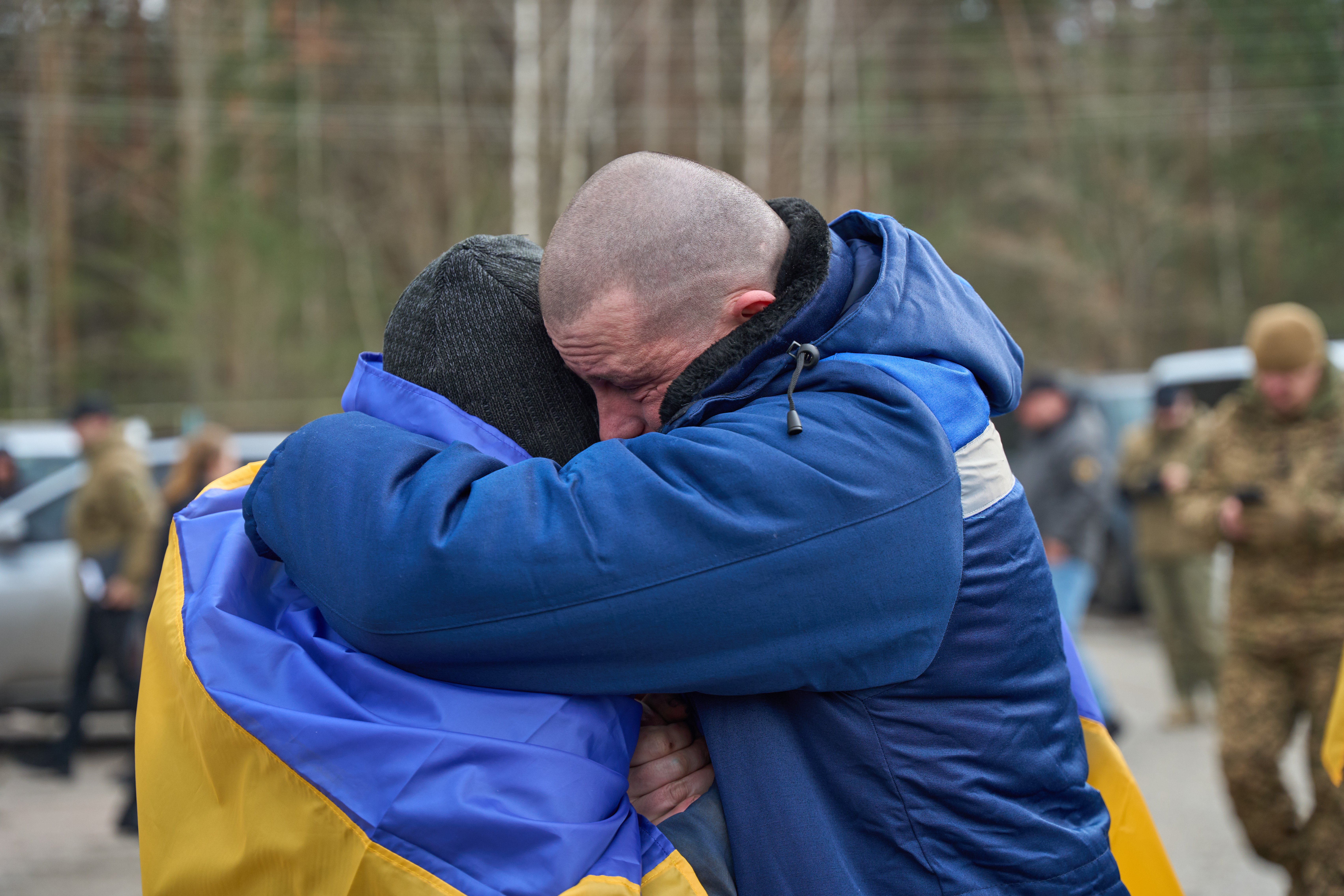 Freed Ukrainian defenders embrace after returning from captivity (previous exchange, March 2026)