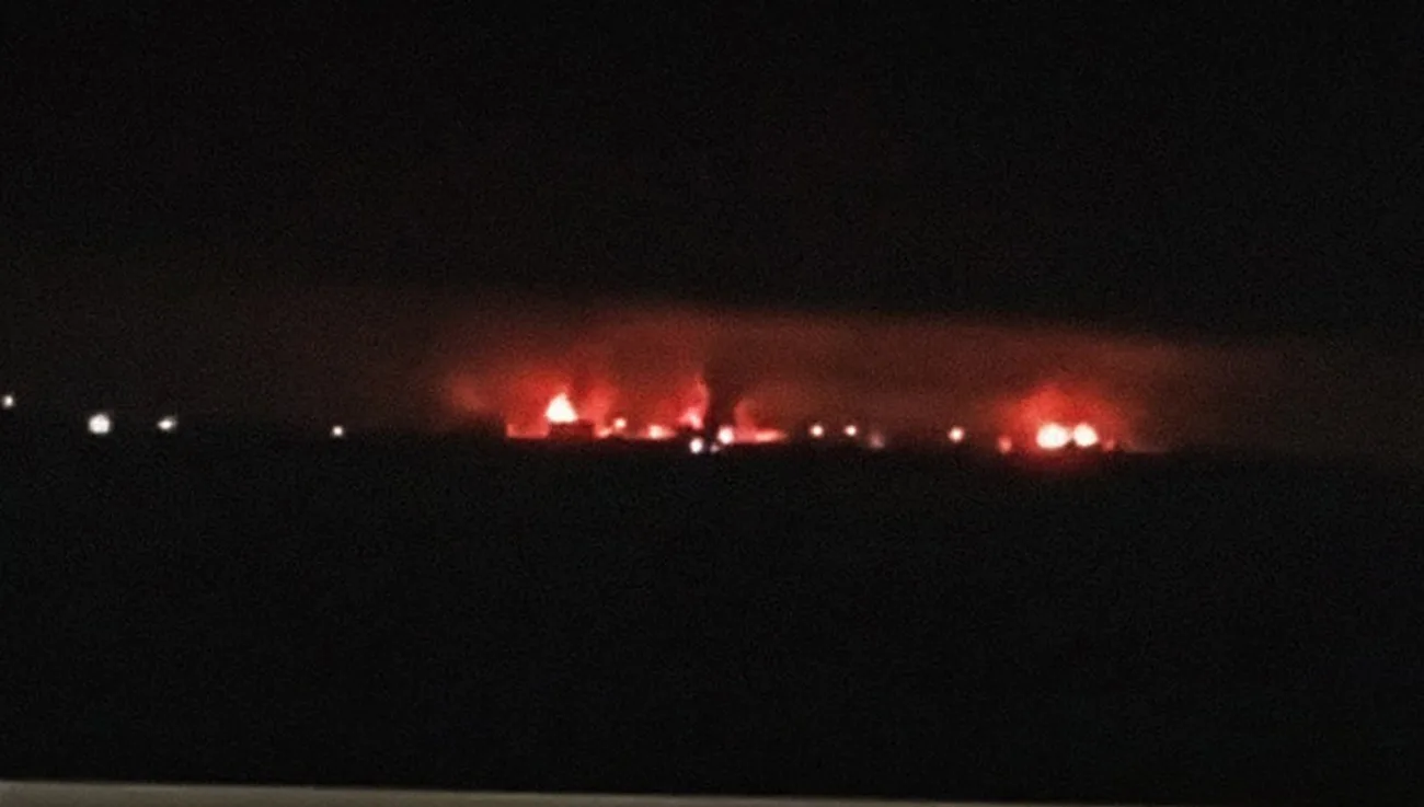 A distant fire glow on the horizon at night after a strike on a refinery in Krasnodar Krai
