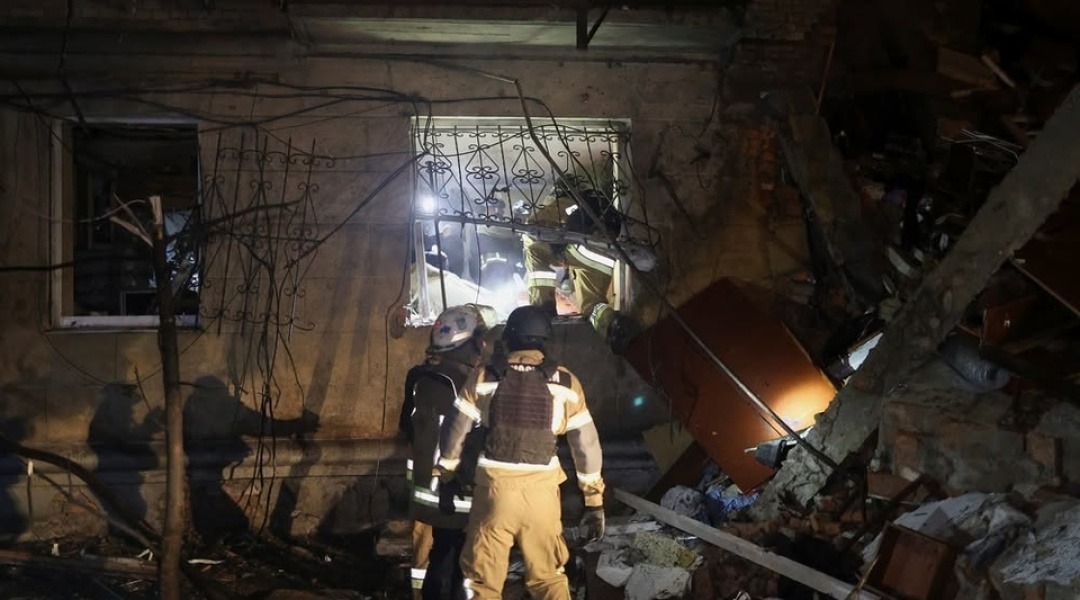 Rescuers clearing the rubble of a destroyed building in Kharkiv