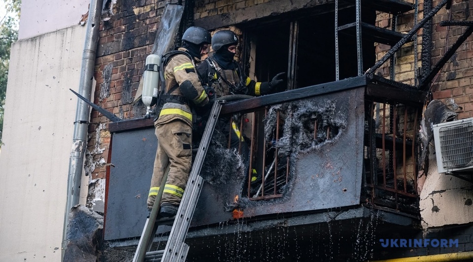 Rescuers deal with the aftermath of a fire in a residential building