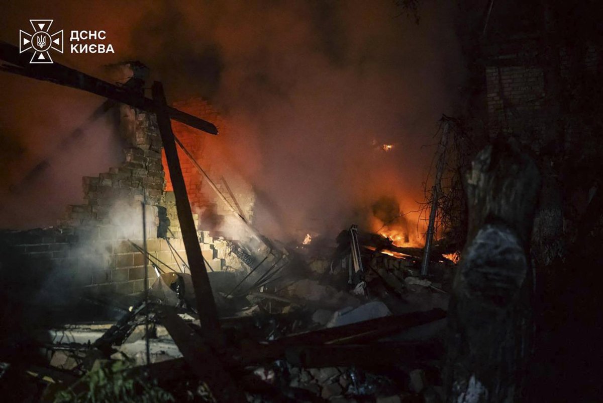The burning wreck of a house at night after the Russian strikes. Photo: State Emergency Service of Kyiv / UPI