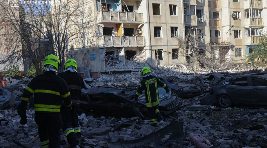 Rescuers working at the site of destroyed apartments