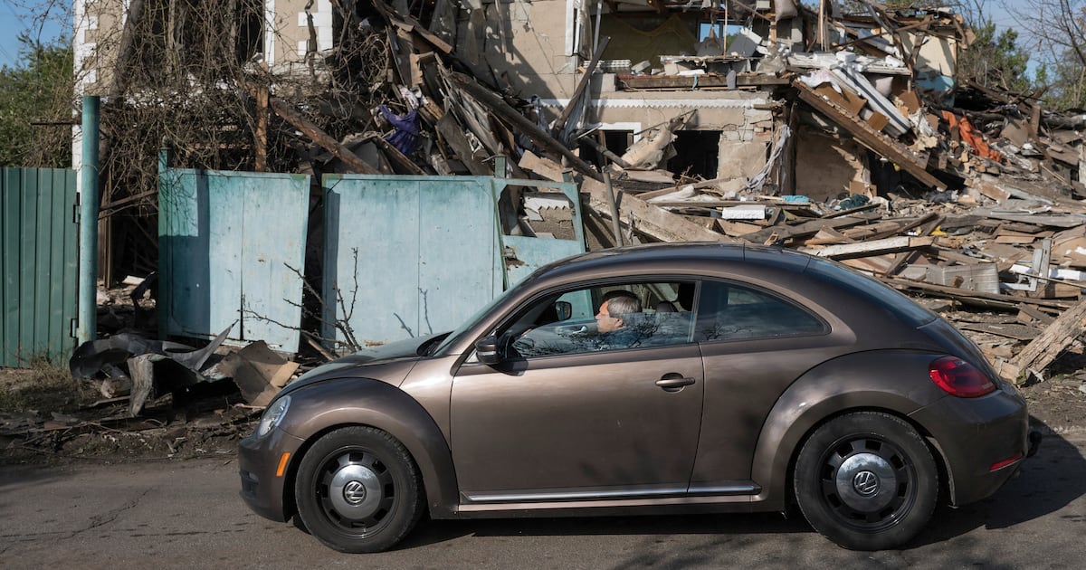 A car drives past a destroyed house in Vyshhorod, north of Kyiv. Photo: AFP / Irish Times