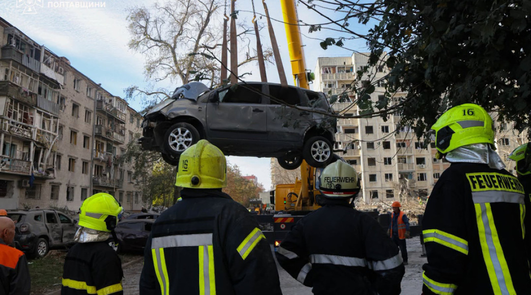 A crane lifts a damaged car out of the ruins in Kremenchuk