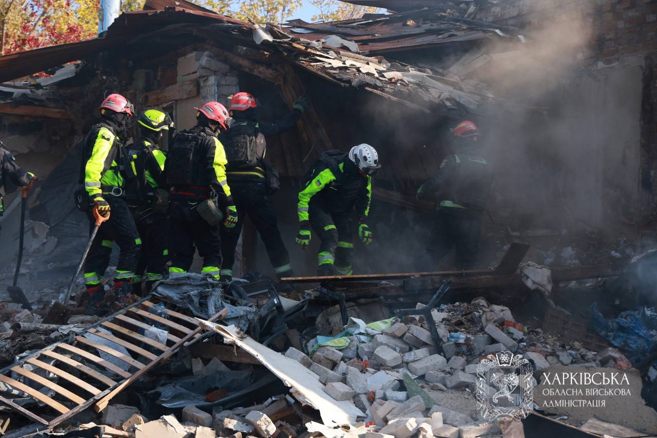 Rescuers clearing rubble after a strike on Kharkiv