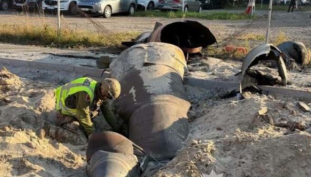 An unexploded missile on the ground in Kyiv's Darnytskyi district, with specialists at work