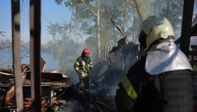 A firefighter at the scene after an enemy strike, illustrative photo