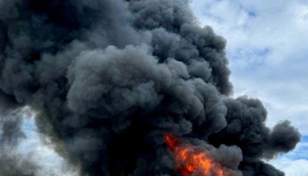 Illustrative photo: thick black smoke over a fire site