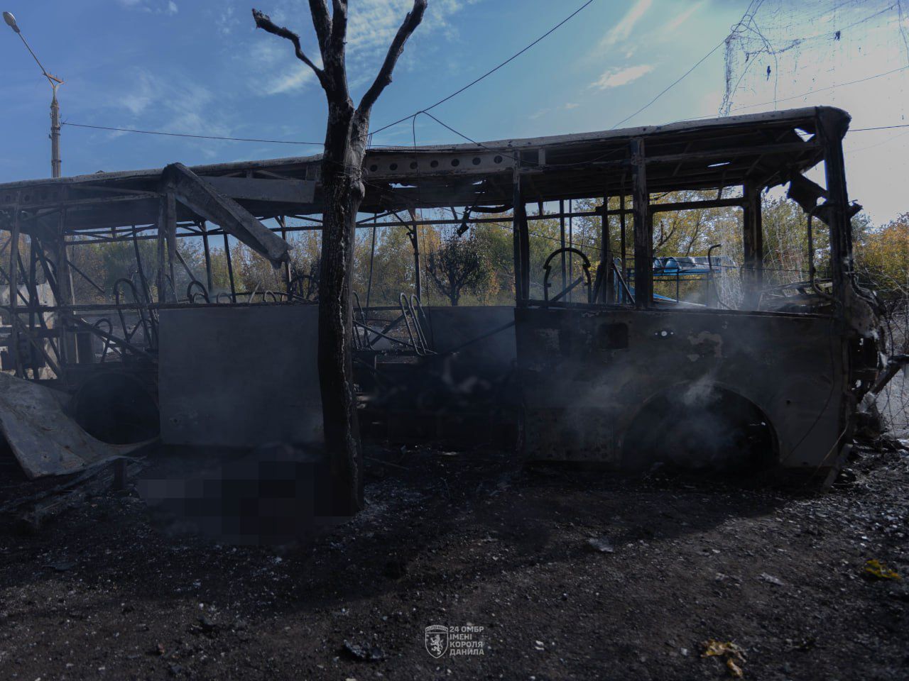 DSNS rescuers next to a burnt-out minibus in Kramatorsk