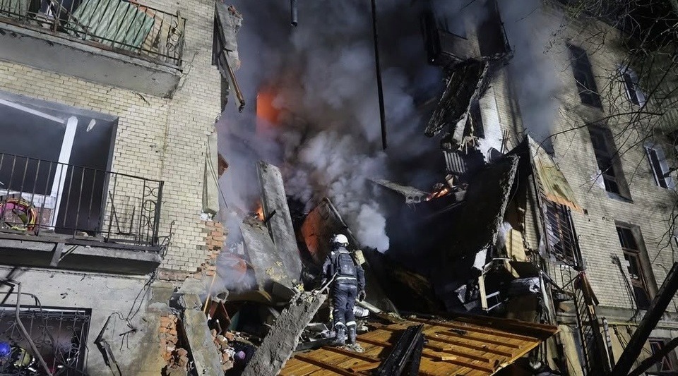 A damaged residential building in Kharkiv after the strike, with rescuers at work