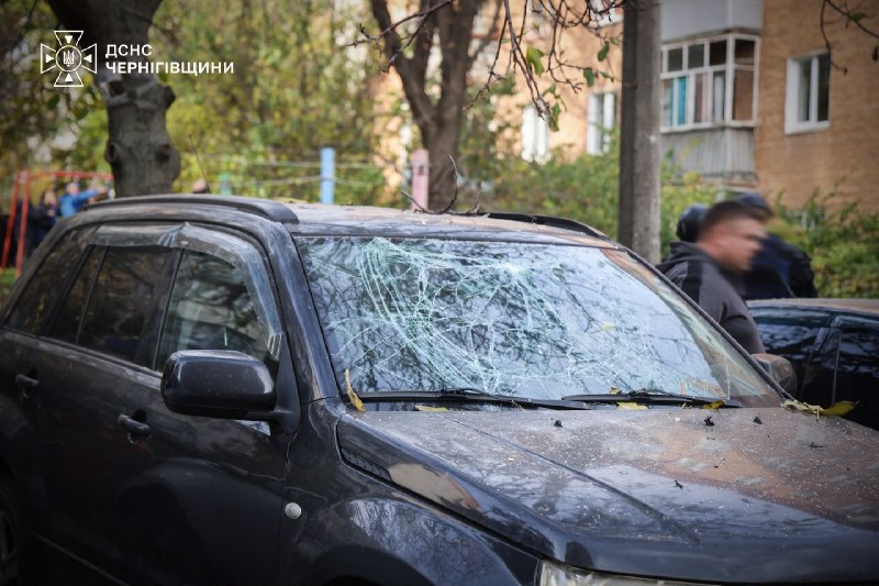 A passenger car with broken glass on the street after the blast