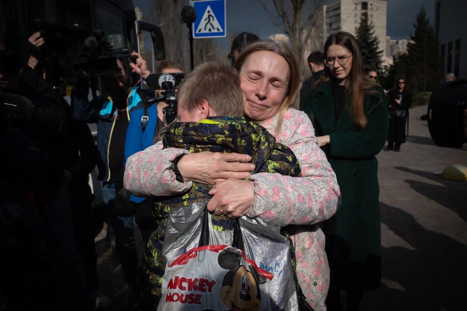 Illustrative file photo (2023): a mother is reunited with her son after his return to Ukraine